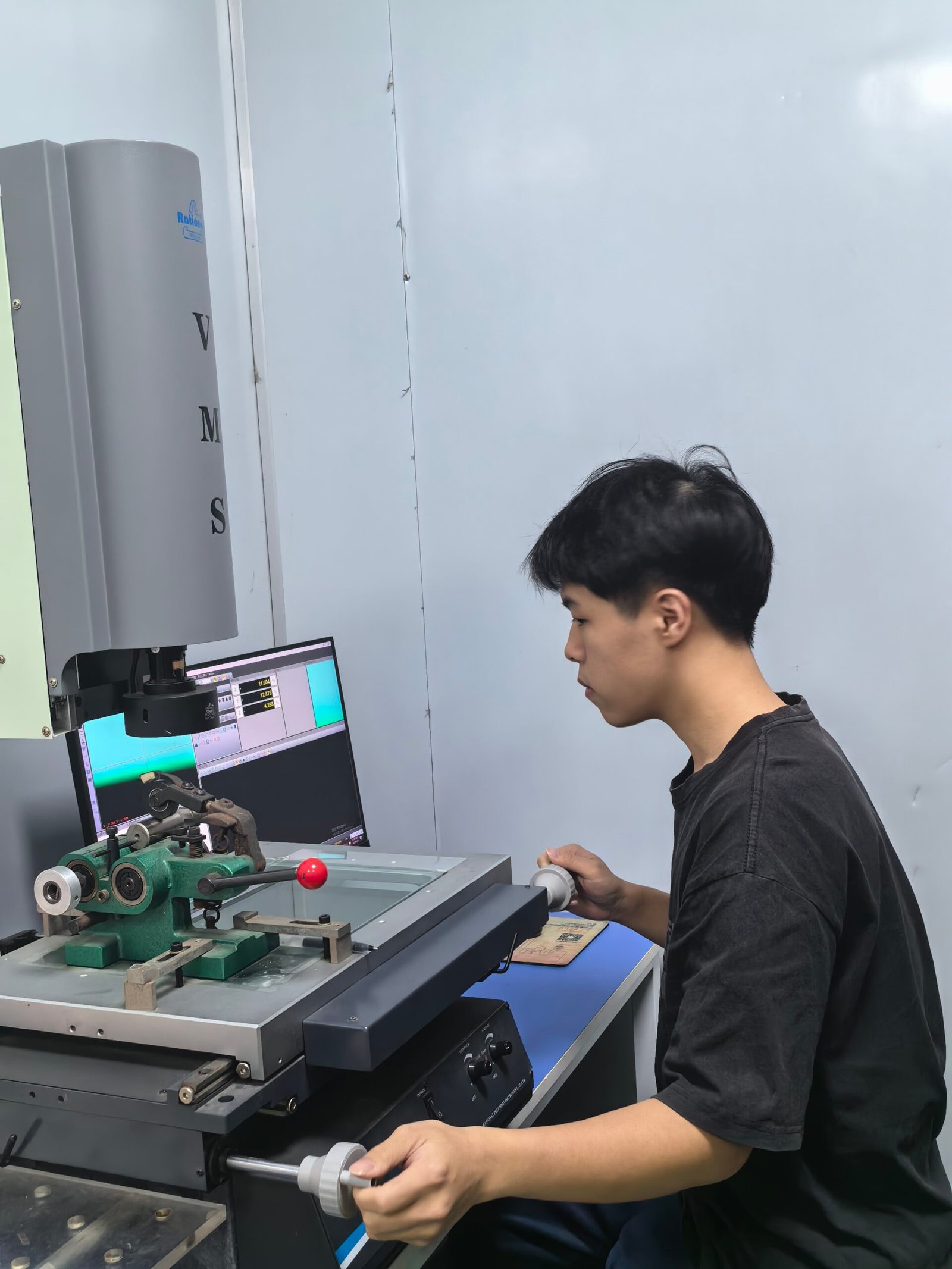 Operator inspecting a woodworking cutting tool with optical measuring equipment